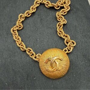 Radiant Gold Toned Chanel Pendant with a Chain bracelet